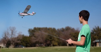 Boy flying RC plane.