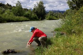 Collecting emergency drinking water from a stream.