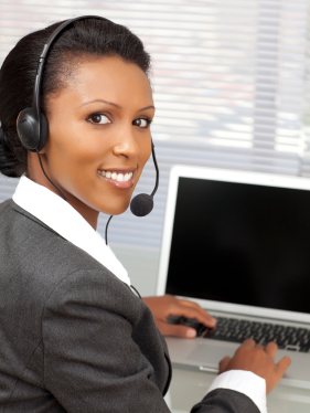 Woman dictating through headphones and keyboard.