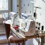 Workshop of seamstress at home - sewing machines and serger on table