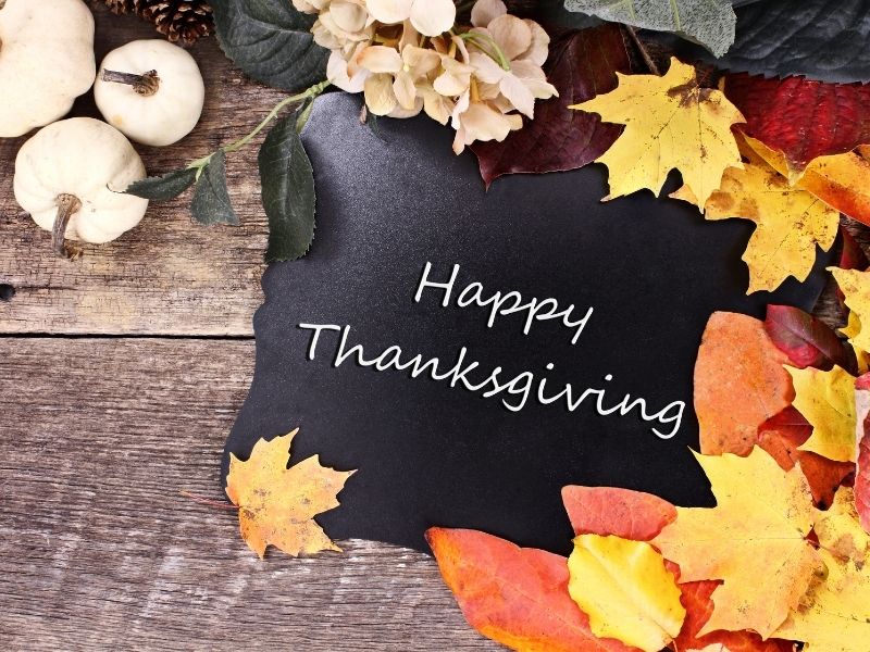 Happy Thanksgiving sign decorated with fall leaves